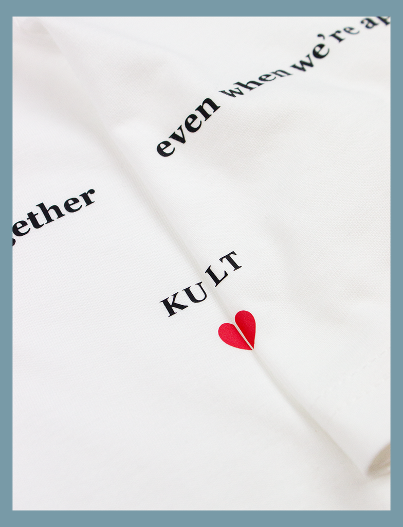 A zoomed in view of the design on the ALWAYS TOGETHER Tee in White by KULT Clothing | The wording and heart symbol overlap together to form the full design | eco-friendly, climate neutral t-shirt