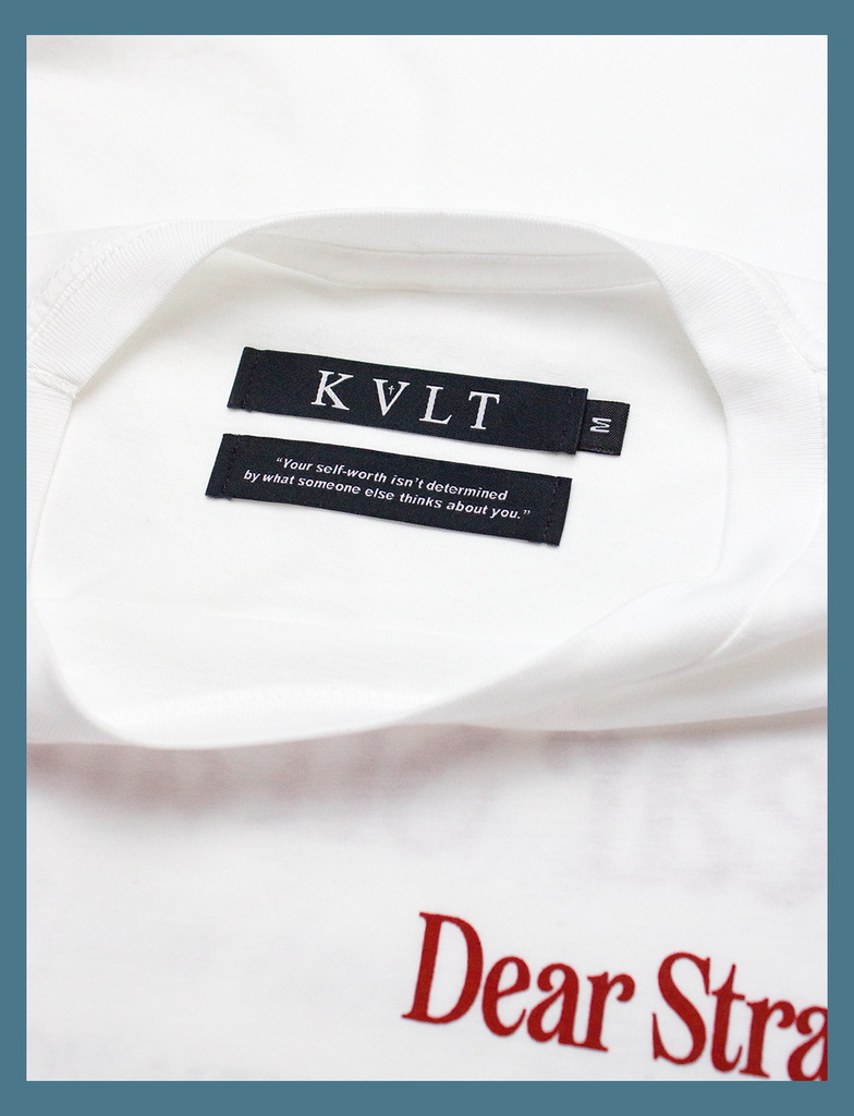 Close-up view of the twin self-worth neck labels on the DEAR STRANGER Tee by KULT Clothing | The bottom label reads "Your self-worth isn't determined by what someone else thinks about you." | Hand-printed using eco friendly inks