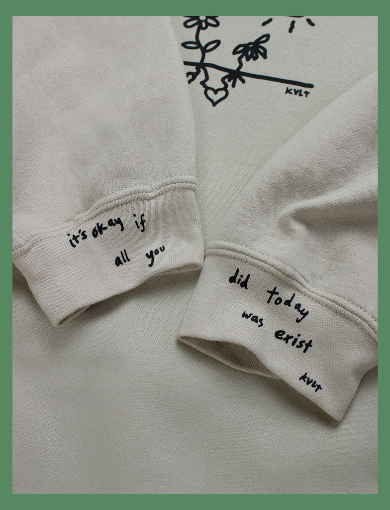 Close-up showcasing the cuff prints on the GROWTH Sweater in Sandstone by KULT Clothing | Created using our Barely There™ matte black vinyl | It's okay if all you did today was exist | KULT