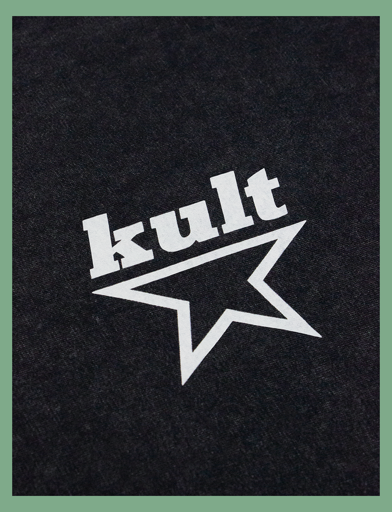 Close-up view of the print on the MEANINGFUL GOALS Tee by KULT Clothing | Featuring the KULT STAR logo on the left breast of the garment | Screen printed by hand in black using eco friendly inks