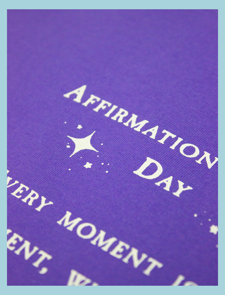 Close-up view on the details of the print on the AFFIRMATIONS Tee in Twilight by KULT Clothing | Affirmation of the Day • Every moment is my moment, whether I realise it or not. | Eco-friendly inks and ethical production