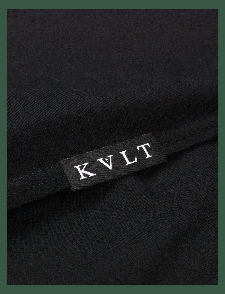 Close-up of the front of the woven hem label on the BLACK MINDS MATTER Charity Tee in Black by KULT Clothing | Please don't hesitate to love me. KULT