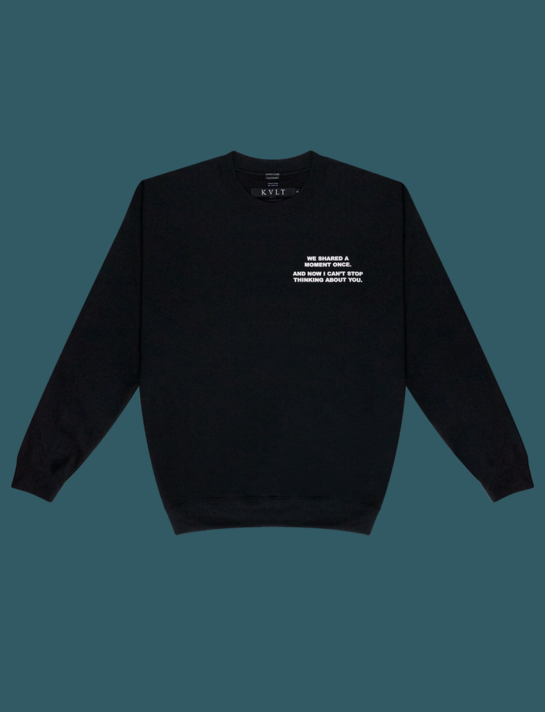 Front view of the DISTANT LOVE Sweater in Black by KULT Clothing | I love it when you miss me. I love when I can feel you hugging me when you aren’t even nearby. You’re like a clothing label brushing against the back of my neck, reminding me I’m loved. KULT
