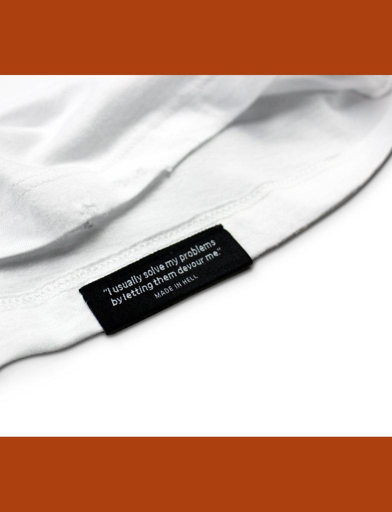 Close-up of the internal hem branding on the BASIK Tee in White