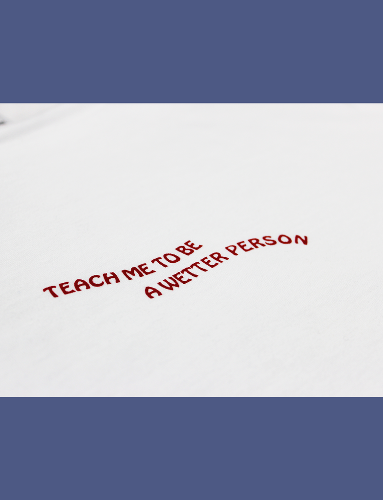 Close-up of the TEACH ME Tee in White by KULT Clothing | "Teach me to be a wetter person"