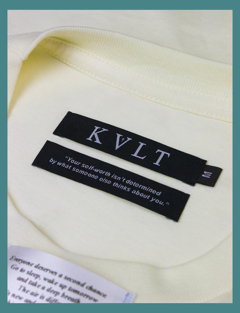 Close-up shot of the dual labels on the inside neckline on SECOND CHANCE Tee in Primrose by KULT Clothing | KVLT | "Your self-worth isn't determined by what someone else thinks about you."
