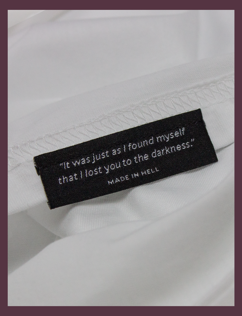 Close-up of the underside hem label on the SUNSHINE Tee by KULT Clothing | You Should Take A Moment To Stop And Look Around Every Once In A While. There's Some Awful Shit Going On. KULT