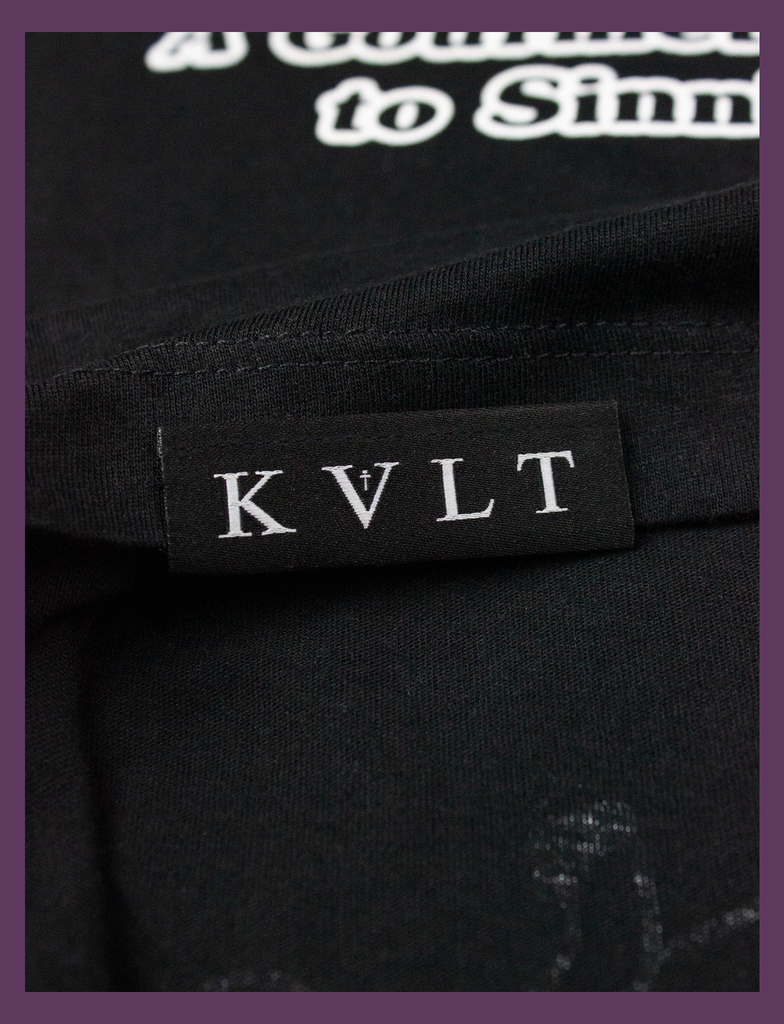 Close-up detailing of the topside hem label on THE JOY OF SATAN Tee in Black by KULT Clothing | The Joy of Satan | A Gourmet Guide to Sinning | KVLT  Edit alt text