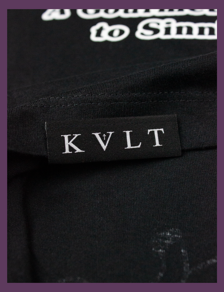 Close-up detailing of the topside hem label on THE JOY OF SATAN Tee in Black by KULT Clothing | The Joy of Satan | A Gourmet Guide to Sinning | KVLT Edit alt text