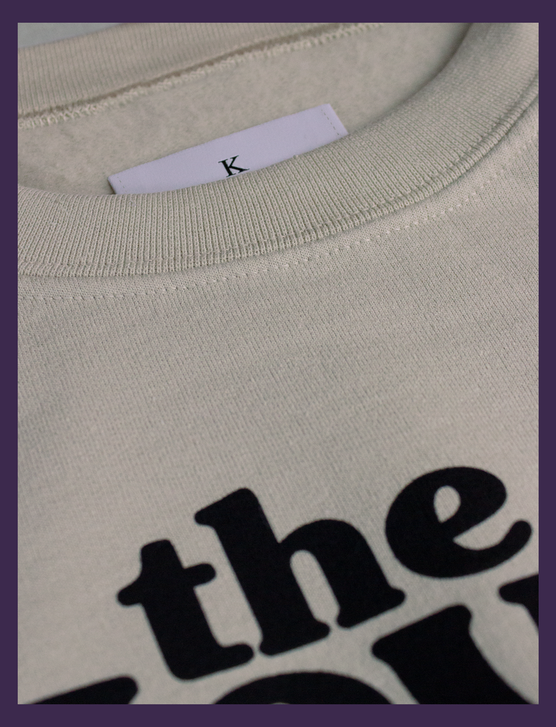 Close-up on the neck label of THE JOY OF SATAN Sweater in Sandstone by KULT Clothing | The Joy of Satan | A Gourmet Guide to Sinning | KULT | KVLT
