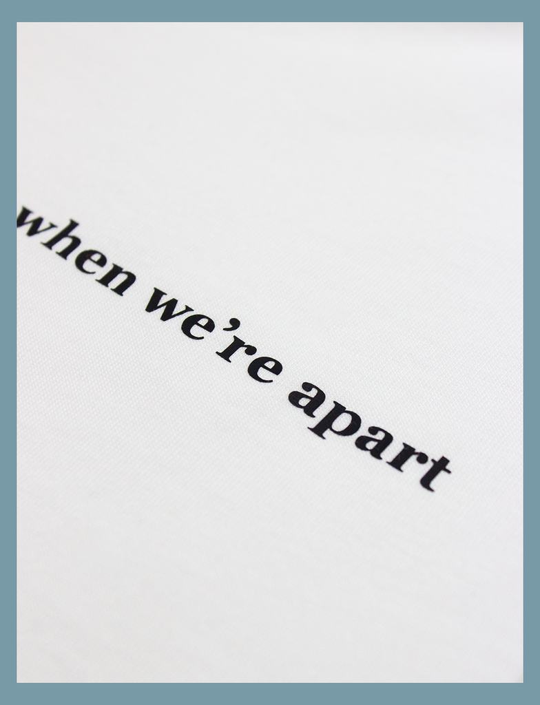 A close-up of the details in the design on the ALWAYS TOGETHER Tee in White by KULT Clothing | It reads "when we're apart" in minute detail | eco-friendly, climate neutral t-shirt