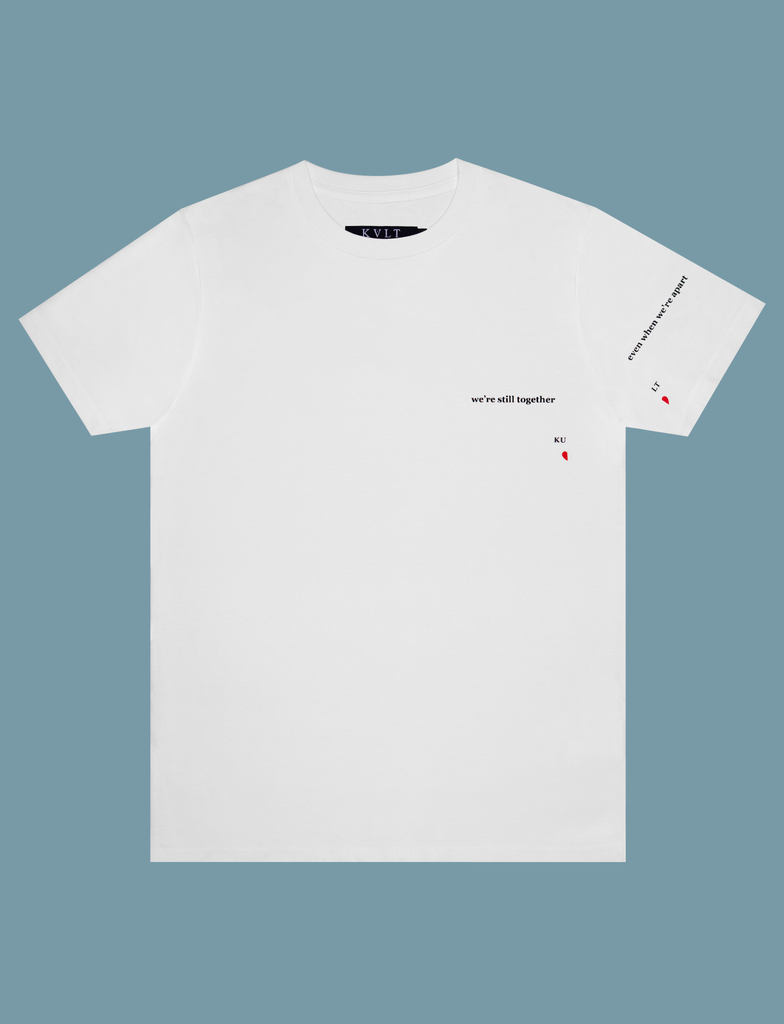 Front view of the ALWAYS TOGETHER Tee in White by KULT Clothing | It reads "We're still together even when we're apart" printed across the left breast and sleeve using our matte black and red Barely There™ vinyl | eco-friendly, climate neutral t-shirt