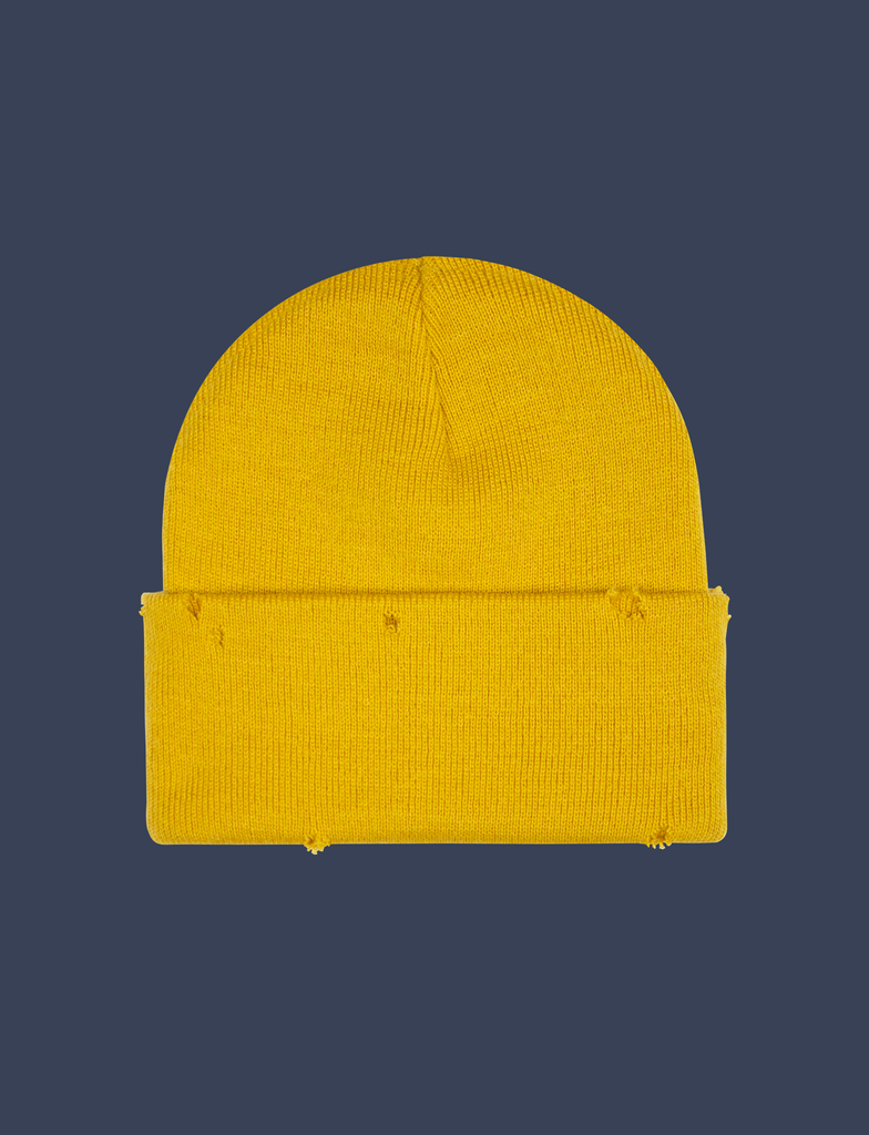 Reverse view of the FLOWERS Beanie in Mustard Yellow by KULT Clothing | It features a speckled cream appliqué label with an embroidered design in cobalt blue thread on the front | 100% acrylic knit beanie hat with distressing across it's construction and design