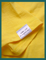 View of the topside of the appliqué label attached at the right cuff on the GOOD DAY Tee by KULT Clothing | It reads 