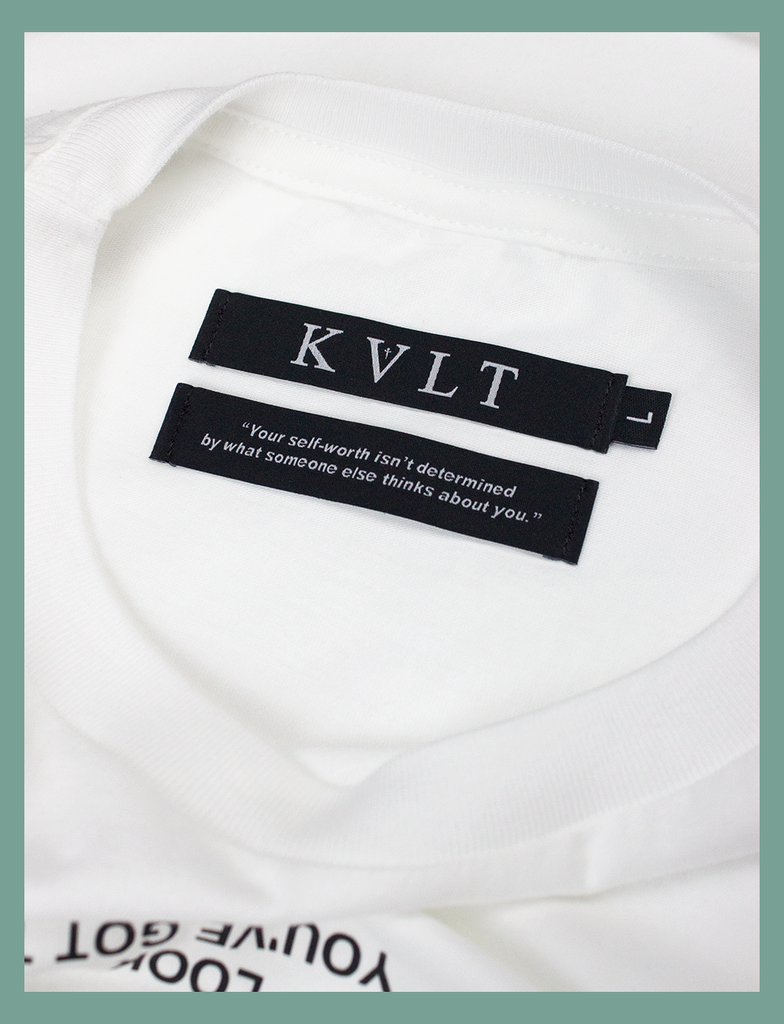 Close-up view of the twin self-worth neck labels on the PAUSE Tee by KULT Clothing | The bottom label reads "Your self-worth isn't determined by what someone else thinks about you." | eco-friendly, climate neutral t-shirt