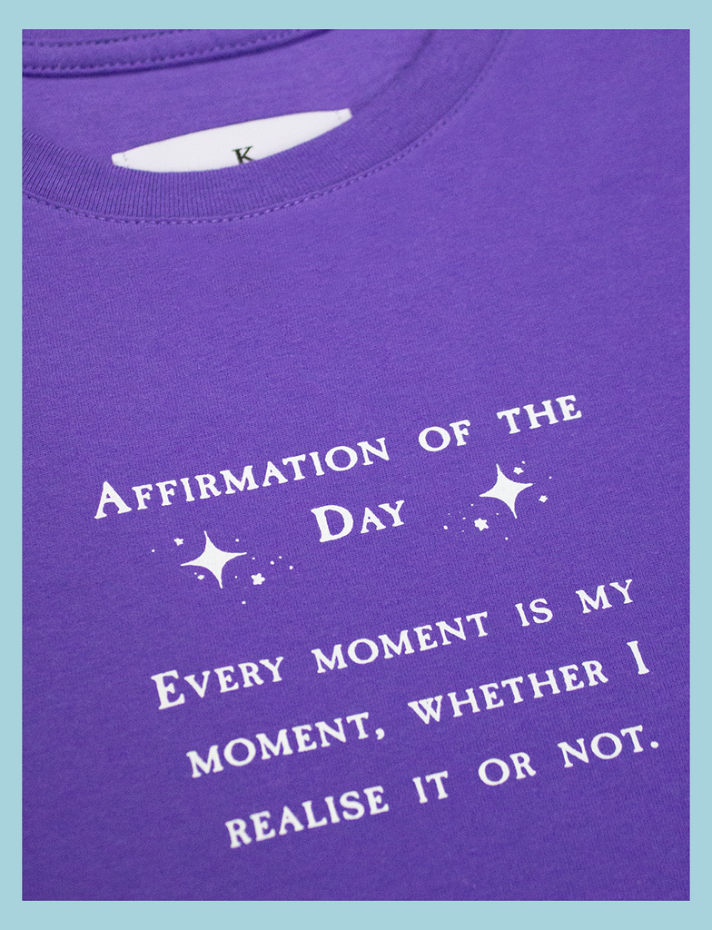 Close-up view of the print on the AFFIRMATIONS Tee in Twilight by KULT Clothing | Affirmation of the Day • Every moment is my moment, whether I realise it or not. | Eco-friendly inks and ethical production