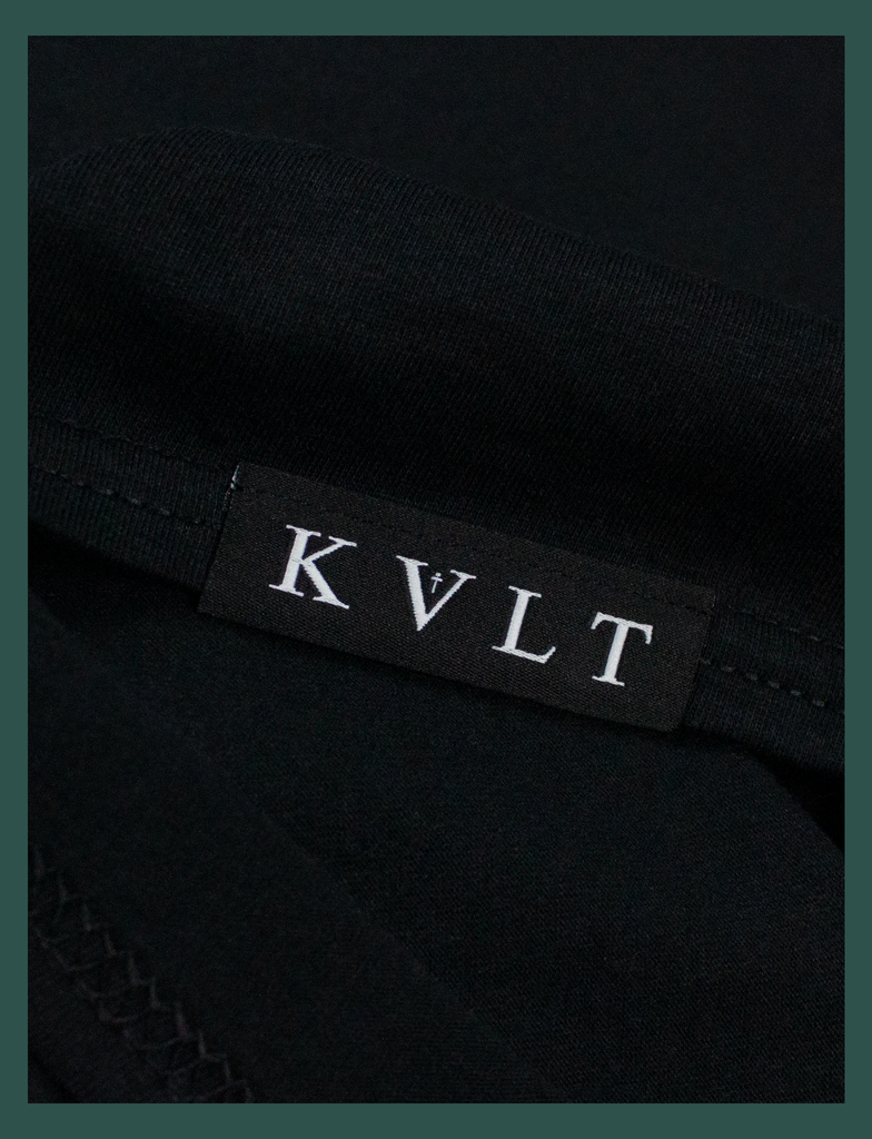 Close-up on the bottom seam label of A WARM HUG Tee in Black by KULT Clothing | When you wear this, I'll always be with you. A warm hug made out of cloth. I love you. KULT