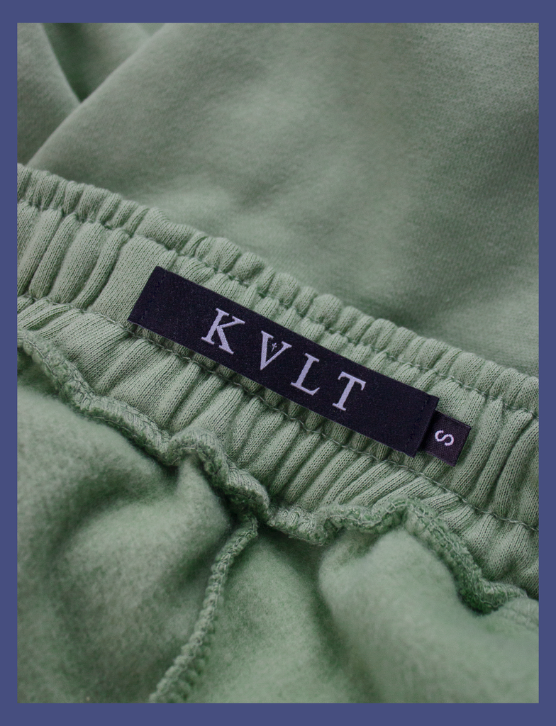 Close-up shot of the KULT sizing label on the inside waistband of the EMBRACE Sweatpants in Sage by KULT Clothing | KVLT