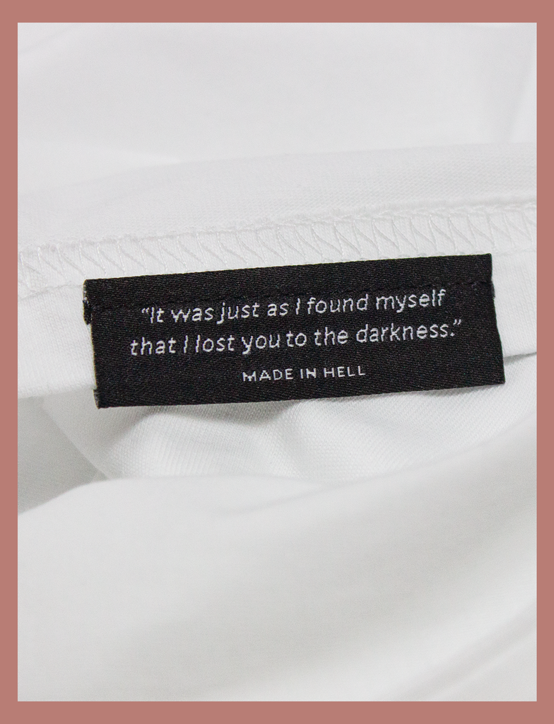 Close-up view of topside hem label on the IT WILL BE OK Longsleeve Tee by KULT Clothing | "It was just as I found myself that I lost you to the darkness." MADE IN HELL