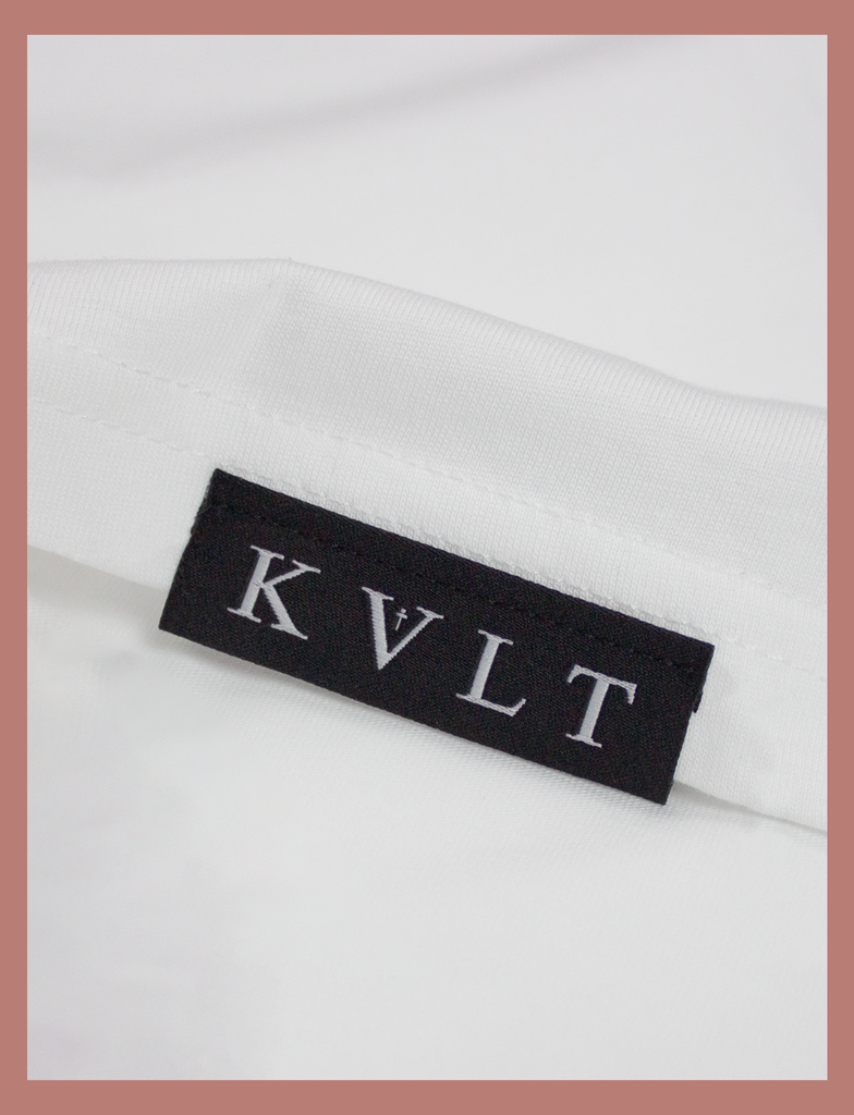 Close-up view of topside hem label on the IT WILL BE OK Longsleeve Tee by KULT Clothing | You are so valuable. No matter what you're going through right now, please know that you're needed. You are loved. It will be ok. KULT
