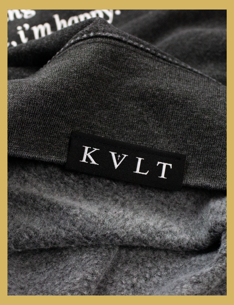 Close-up view of the topside hem label on the JOY Sweater by KULT Clothing | Aren't we all just doing stuff so we can get a hit of joy? What does it matter where you got that feeling, as long as it isn't hurting anyone else? Leave me be, I'm happy.