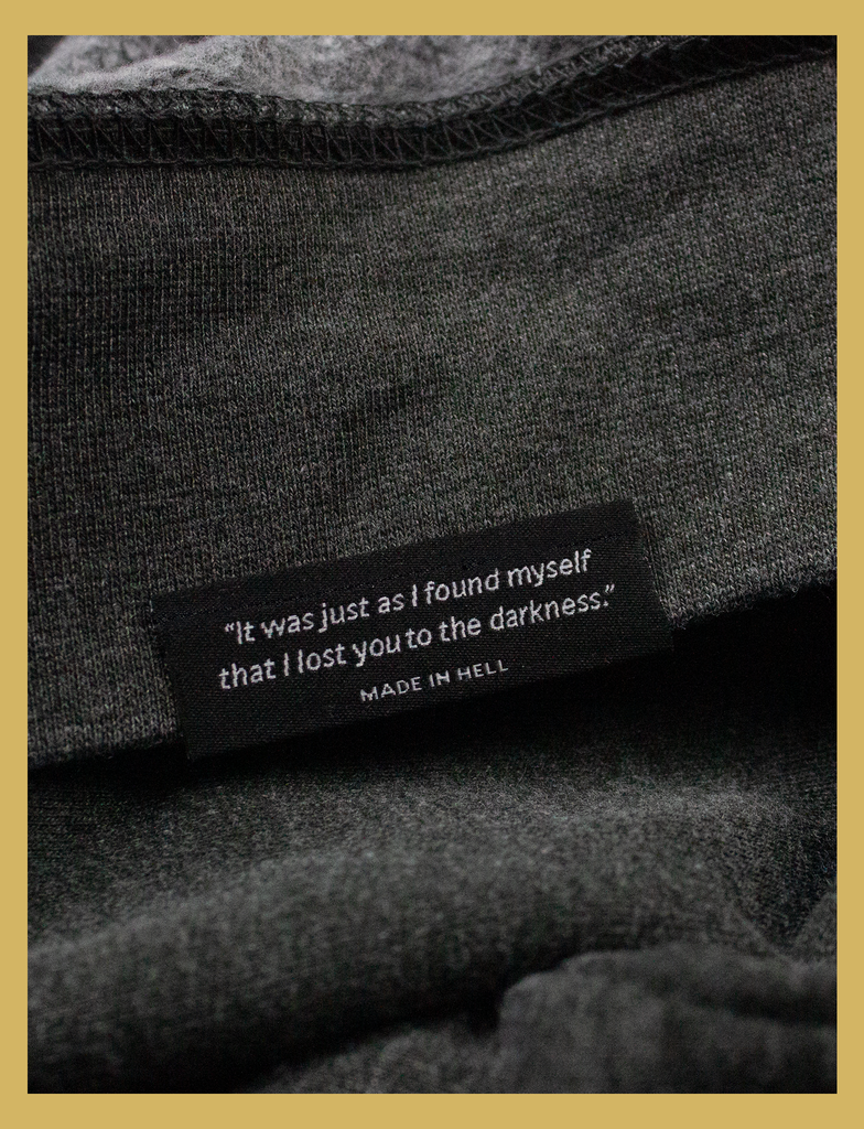 Close-up view of the underside hem label on the JOY Sweater by KULT Clothing | Aren't we all just doing stuff so we can get a hit of joy? What does it matter where you got that feeling, as long as it isn't hurting anyone else? Leave me be, I'm happy.