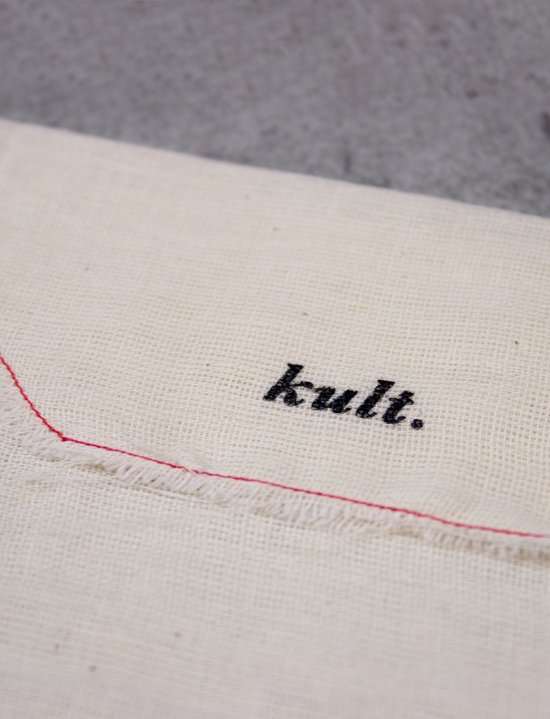 Close-up of the hand-printed KULT branding, made using eco friendly black ink.