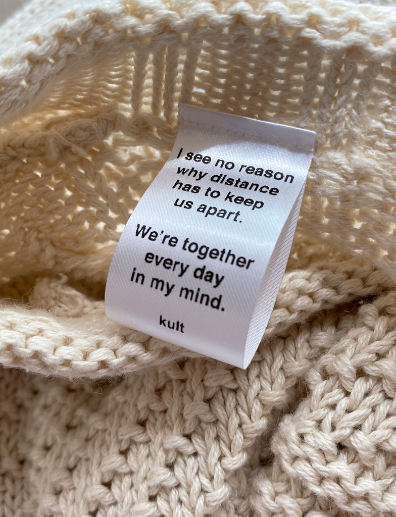 Close-up shot of one of the satin labels that has been applied to a meaningful garment in-house by KULT. | I see no reason why distance has to keep us apart. We're together every day in my mind. KULT