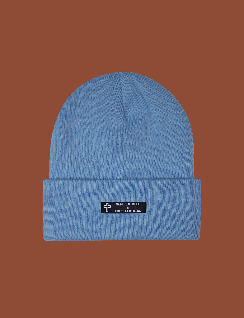 Front of the MADE IN HELL Beanie in Pastel Blue by KULT Clothing | Black appliqué label on the front of a pastel blue, 100% acrylic knit beanie hat
