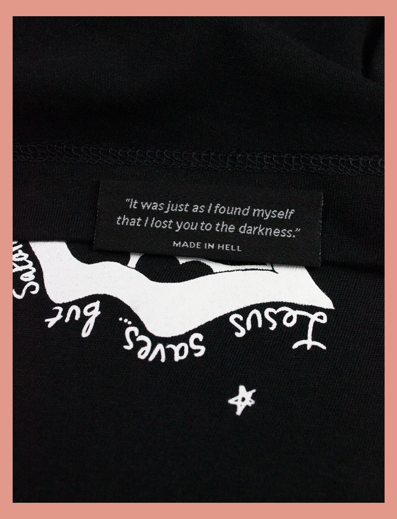 Close-up detailing of the underside hem label on the SATAN'S TONGUE Tee in Black by KULT Clothing | Jesus saves... but Satan does that thing with his tongue | "It was just as I found myself that I lost you to the darkness." MADE IN HELL