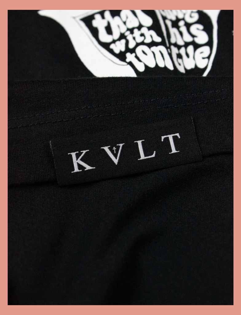Close-up detailing of the topside hem label on the SATAN'S TONGUE Tee in Black by KULT Clothing | Jesus saves... but Satan does that thing with his tongue | KVLT