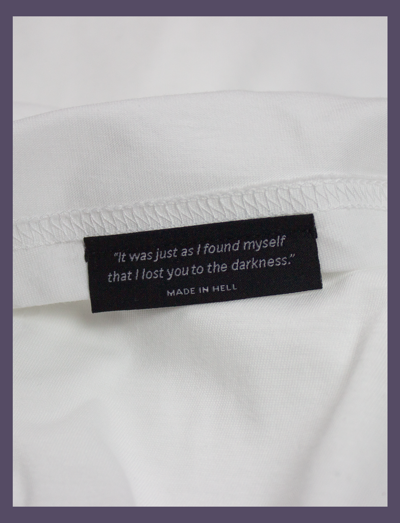 Close-up of the underside hem label on the SMALL FEELINGS Tee by KULT Clothing | "It was just as I found myself that I lost you to the darkness." Made In Hell