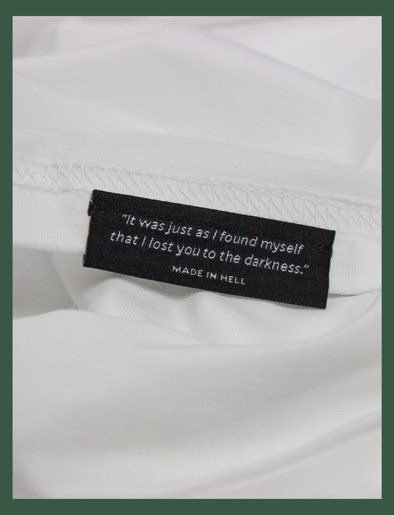 Close-up of the underside hem label on the SOCIAL DISTANCING Tee by KULT Clothing | "It was just as I found myself that I lost you to the darkness." Made In Hell