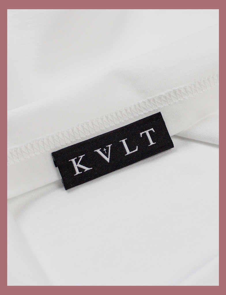 Close-up view of the topside hem label on the SUNSHINE Tee by KULT Clothing | Sunshine on my skin, I feel me again.