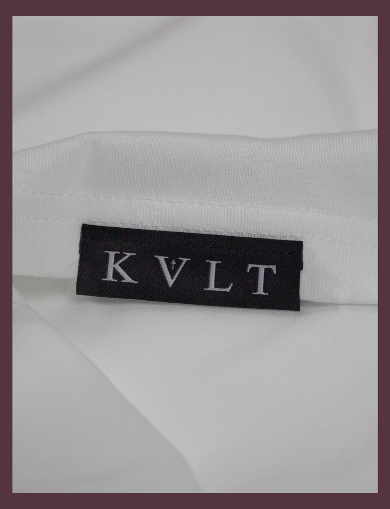 Close-up of the top side hem label on the SUNSHINE Tee by KULT Clothing | You Should Take A Moment To Stop And Look Around Every Once In A While. There's Some Awful Shit Going On. KULT