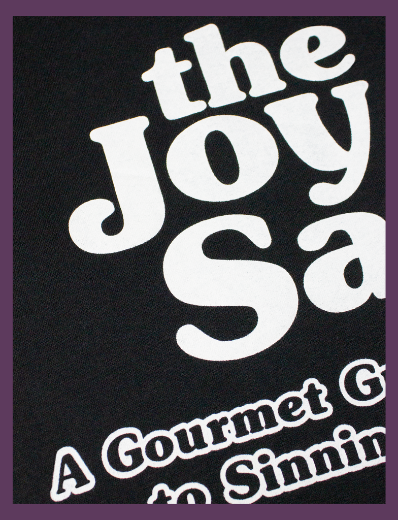 Close-up view of the screen printed design on the front of THE JOY OF SATAN Tee in Black by KULT Clothing | The Joy of Satan | A Gourmet Guide to Sinning | KVLT