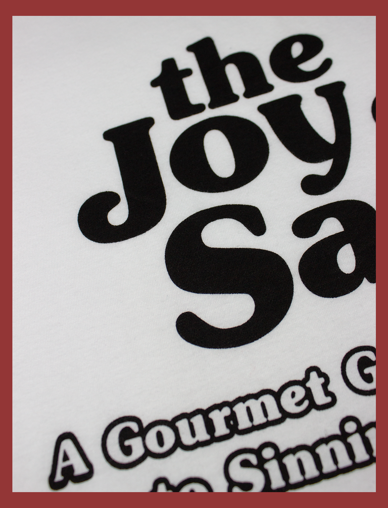 Close-up view of the screen printed design on the front of THE JOY OF SATAN Tee  in White by KULT Clothing | The Joy of Satan | A Gourmet Guide to Sinning | KVLT