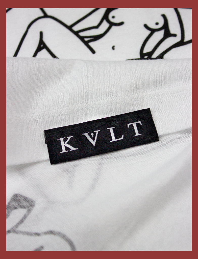 Close-up detailing of the topside hem label on THE JOY OF SATAN Tee in White by KULT Clothing | The Joy of Satan | A Gourmet Guide to Sinning | KVLT