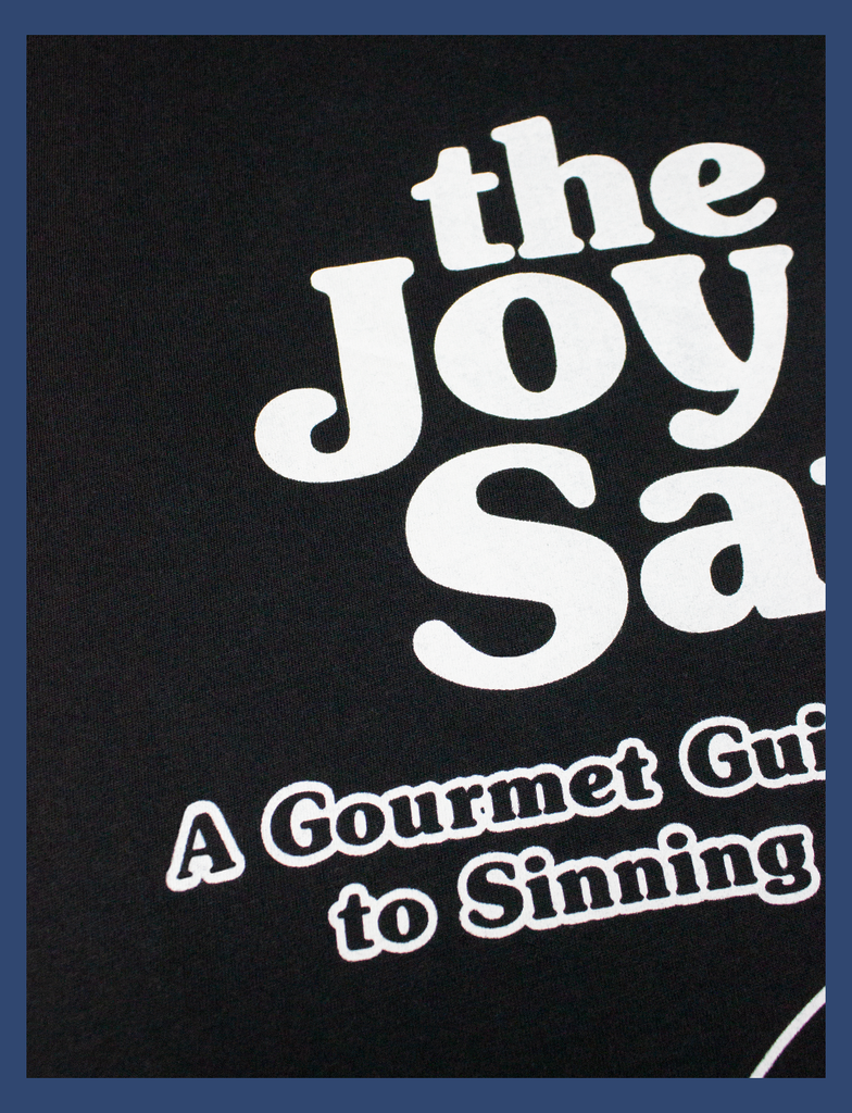 A more detailed view of the typography and print on THE JOY OF SATAN Sweater in Black by KULT Clothing | The Joy of Satan | A Gourmet Guide to Sinning | KULT