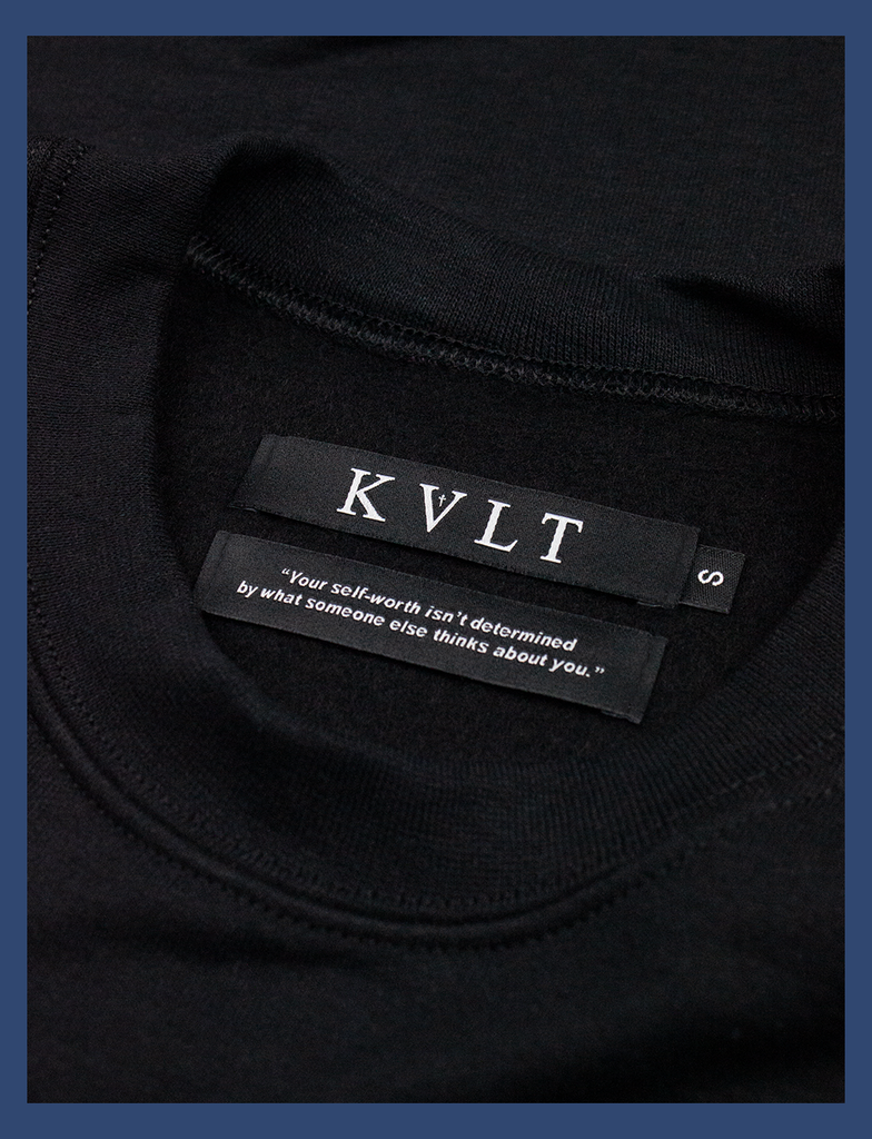 Close-up shot of the dual labels on the inside neckline on THE JOY OF SATAN Sweater in Black by KULT Clothing | KVLT | "Your self-worth isn't determined by what someone else thinks about you."