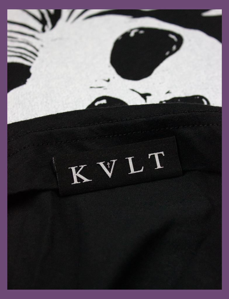 Close-up detailing of the topside hem label on the WAKE ME UP Tee in Black by KULT Clothing | Wake me up when you're over yourself. | KVLT
