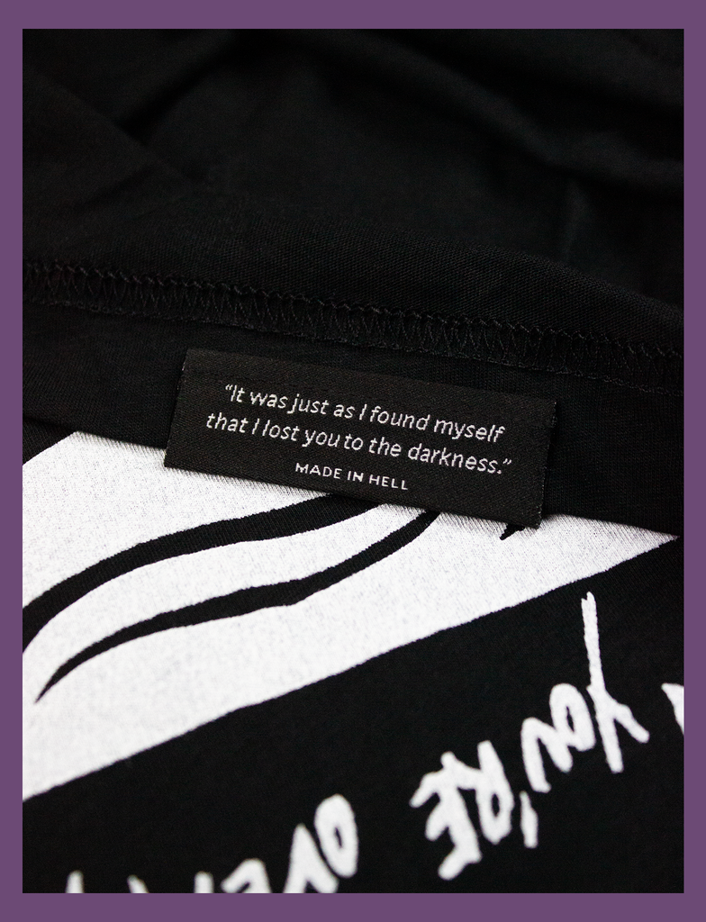 Close-up detailing of the underside hem label on the WAKE ME UP Tee in Black by KULT Clothing | Wake me up when you're over yourself. | "It was just as I found myself that I lost you to the darkness." MADE IN HELL